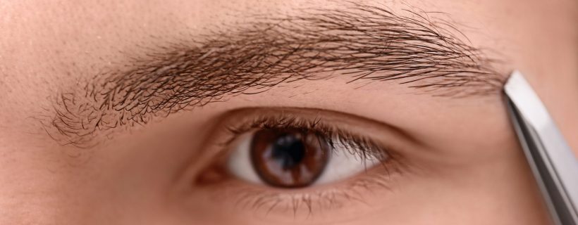 Young,Man,Tweezing,His,Eyebrow,,Closeup